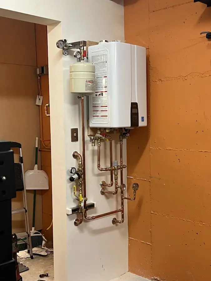 Plumbing technician inspecting water heater connections in Cleveland